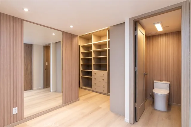 a view of a hallway with toilet and sink