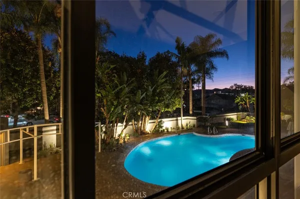 a view of a swimming pool with a table and chairs