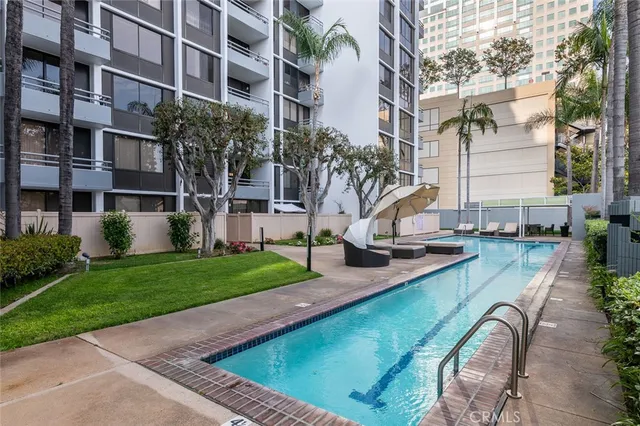 a patio with a table and chairs under an umbrella
