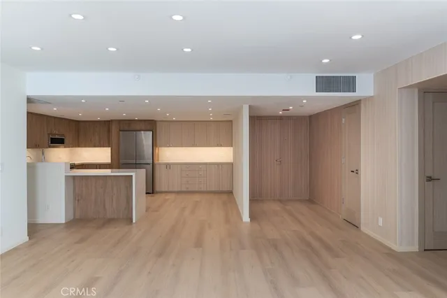 a kitchen with a refrigerator and a sink