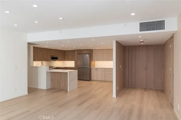 a kitchen with a sink stainless steel appliances and cabinets