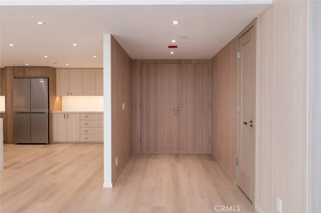 a view of a hallway with wooden floor