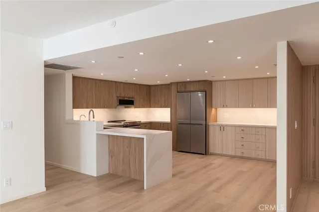 a kitchen with a stove a refrigerator and a sink