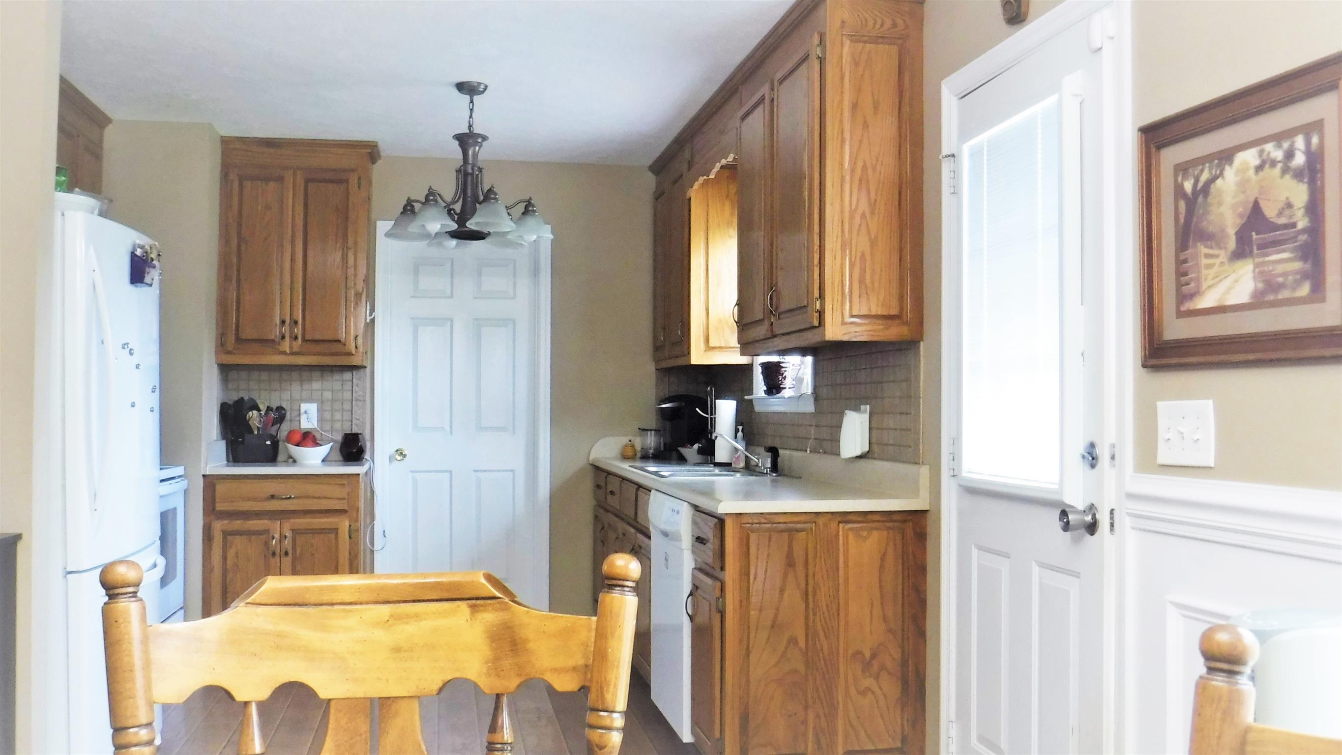 8 Merideth Lynn Road Fayetteville, TN 37334 - Photo 7 of 19 a kitchen with stainless steel appliances granite countertop a refrigerator a sink dishwasher and wooden cabinets with wooden floor