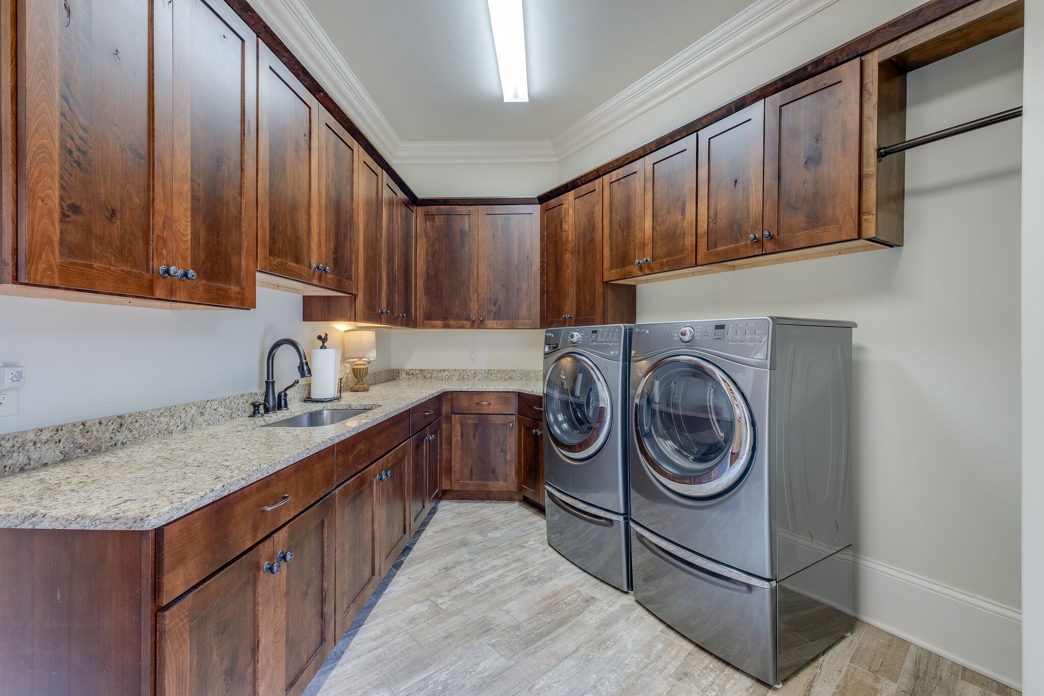 4411 Peytona Lane Franklin, TN 37064 - Photo 34 of 50 a kitchen with kitchen island granite countertop a sink a stove cabinets and washer dryer