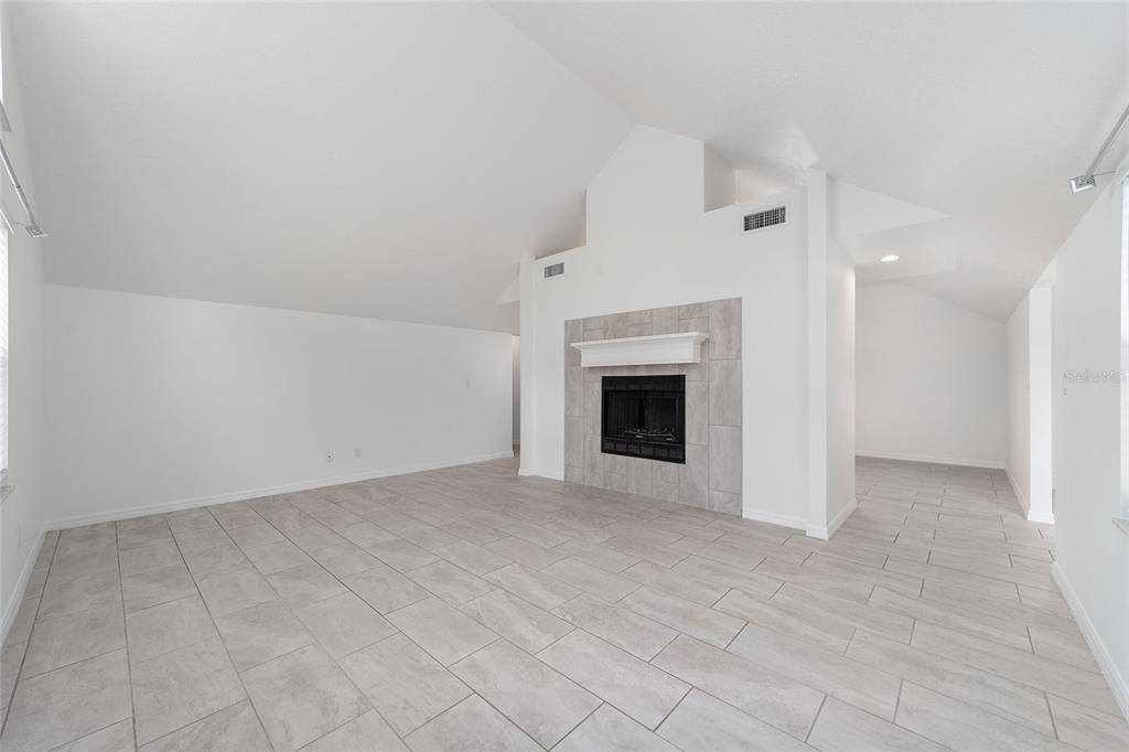 2159 Southeast 7th Terrace Ocala, FL 34471 - Photo 12 of 59 an empty room with white walls and fireplace