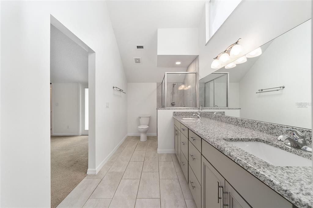 2159 Southeast 7th Terrace Ocala, FL 34471 - Photo 27 of 59 a bathroom with a granite countertop double vanity sink and a mirror