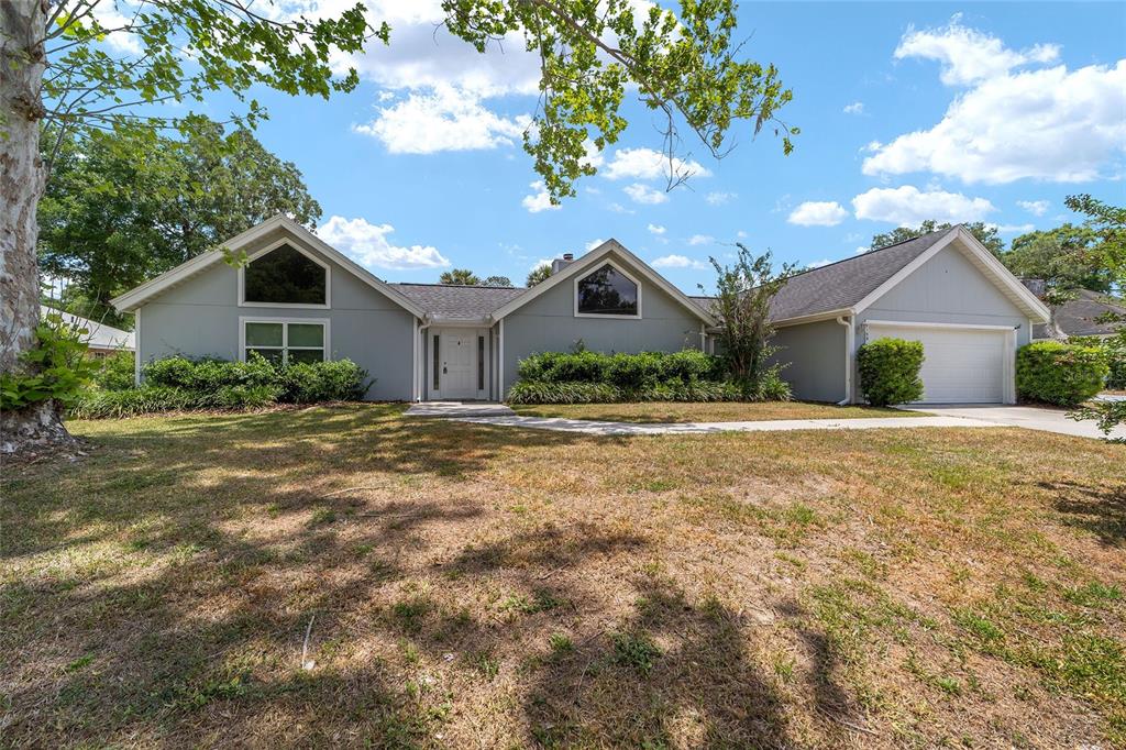 2159 Southeast 7th Terrace Ocala, FL 34471 - Photo 6 of 59 a front view of a house with a garden