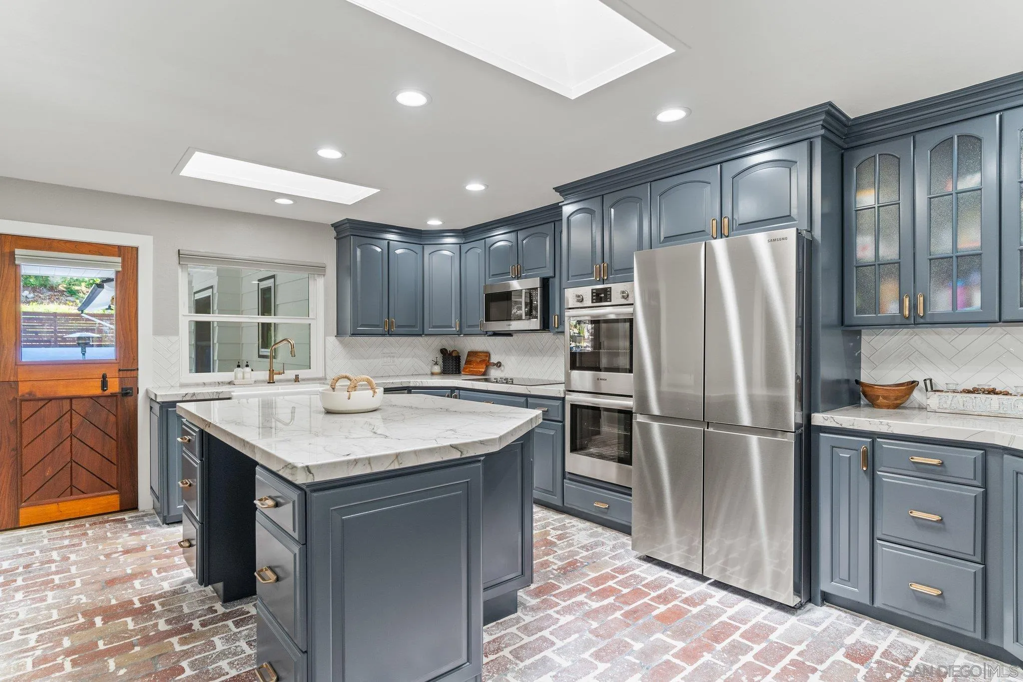 13229 Stone Canyon Road Poway, CA 92064 - Photo 7 of 29 a kitchen with kitchen island a sink refrigerator and cabinets