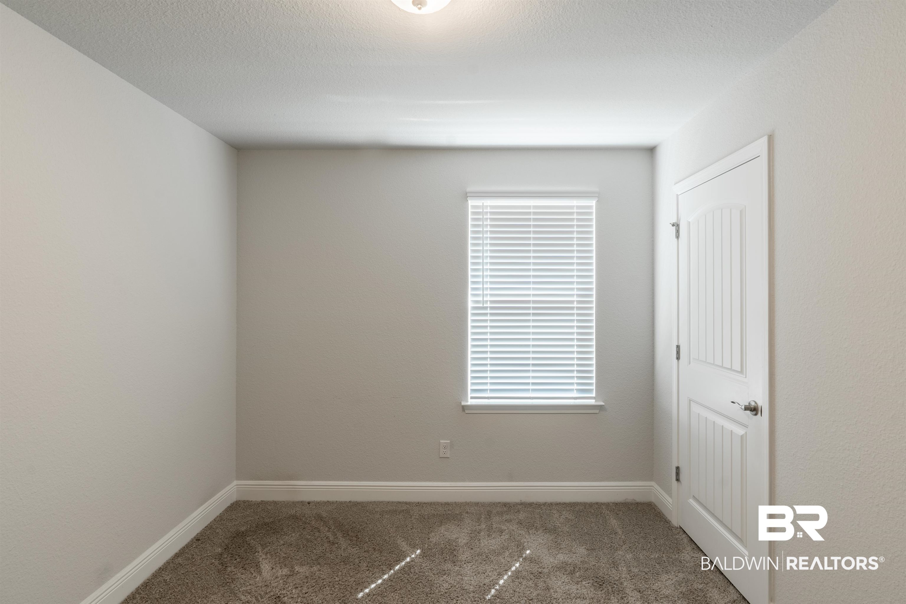 1906 Stonepine Drive South Semmes, AL 36575 - Photo 16 of 30 Carpeted empty room with a textured ceiling
