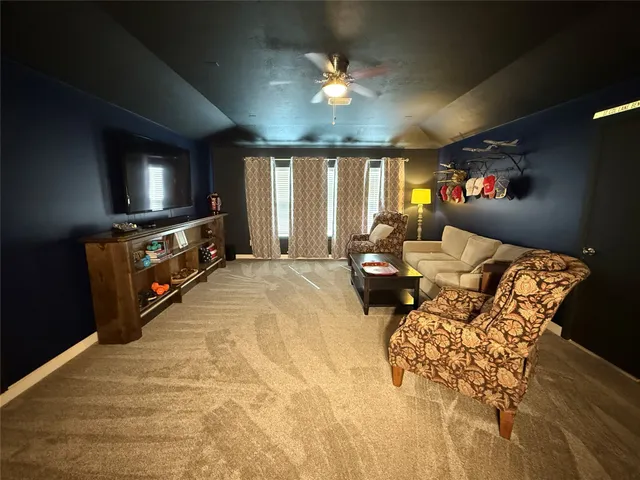 a bed room with furniture and a flat screen tv