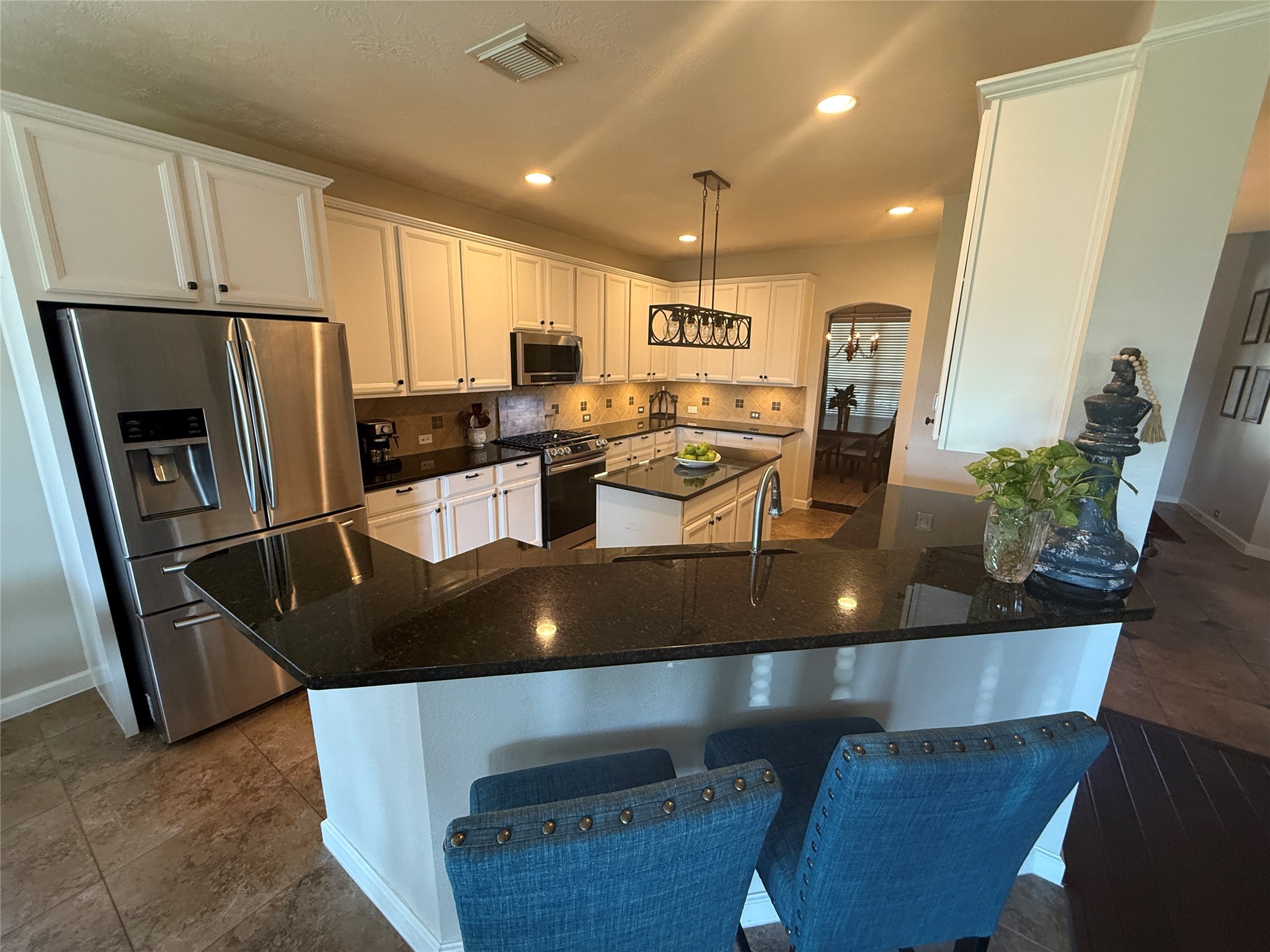 1631 Andrew Chase Lane Spring, TX 77386 - Photo 4 of 16 a kitchen with stainless steel appliances granite countertop a sink refrigerator and microwave
