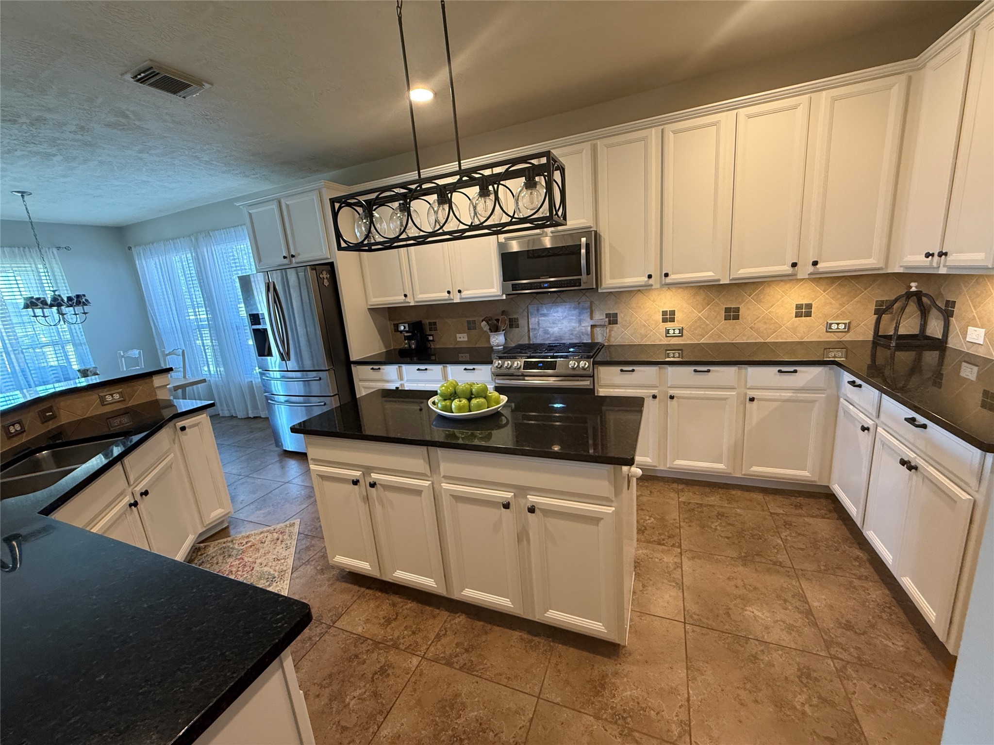 1631 Andrew Chase Lane Spring, TX 77386 - Photo 5 of 16 a kitchen with stainless steel appliances granite countertop a sink a stove and cabinets