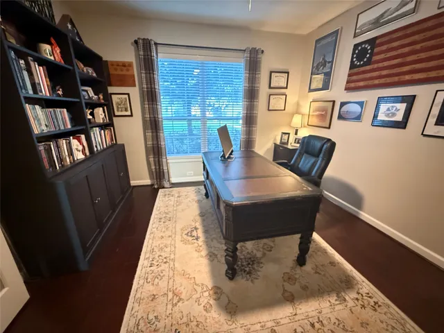 a living room with furniture and a book shelf
