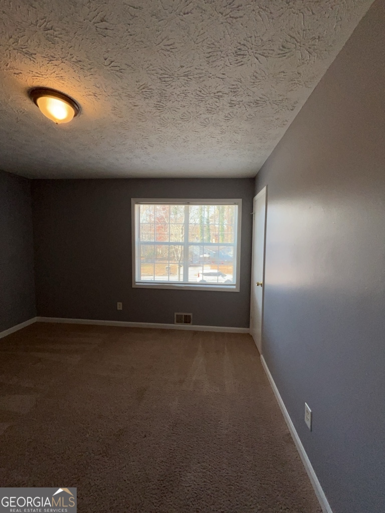 1682 Charmeth Road Lithonia, GA 30058 - Photo 18 of 52 an empty room with a window