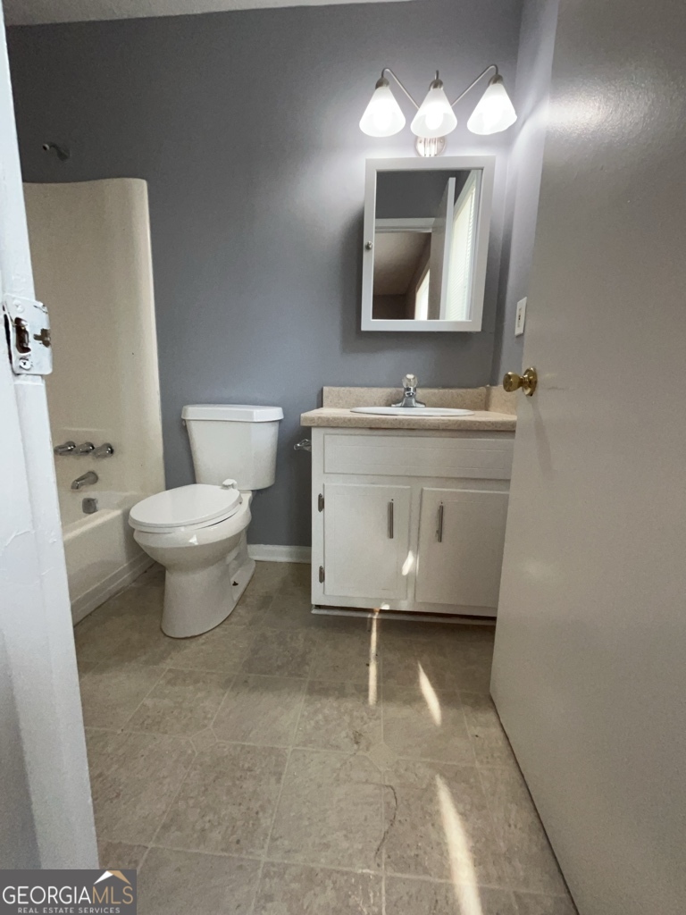 1682 Charmeth Road Lithonia, GA 30058 - Photo 20 of 52 a bathroom with a toilet sink and mirror