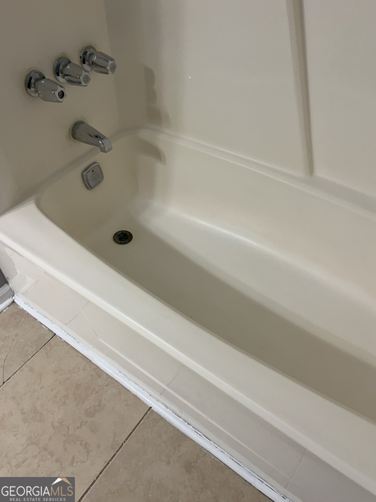 1682 Charmeth Road Lithonia, GA 30058 - Photo 21 of 52 a bathroom with a bathtub