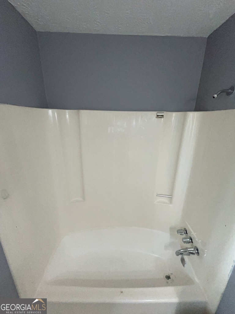 1682 Charmeth Road Lithonia, GA 30058 - Photo 29 of 52 a bathroom with a bathtub