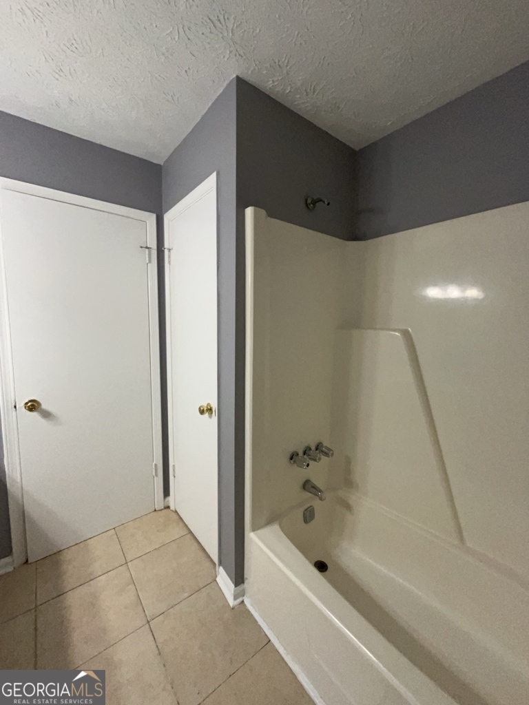 1682 Charmeth Road Lithonia, GA 30058 - Photo 30 of 52 a bathroom with a bathtub and a shower