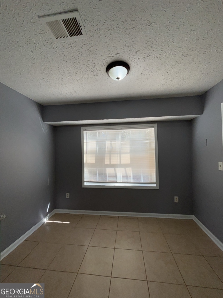 1682 Charmeth Road Lithonia, GA 30058 - Photo 33 of 52 a view of an empty room with a window