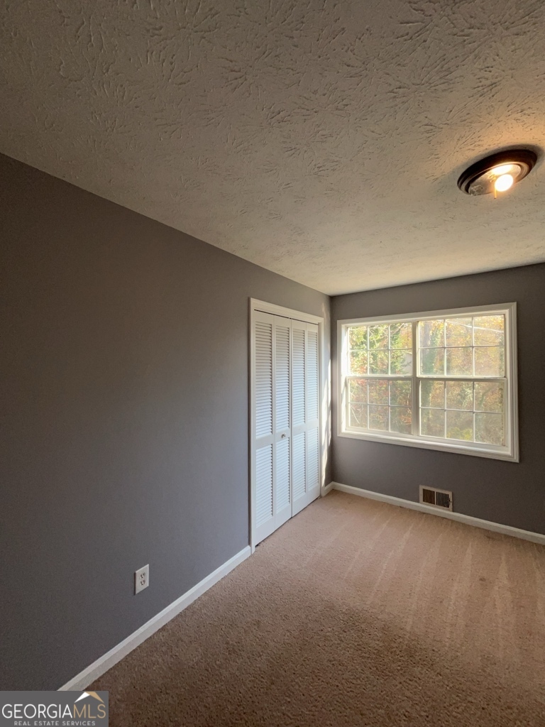 1682 Charmeth Road Lithonia, GA 30058 - Photo 36 of 52 a view of an empty room with a window