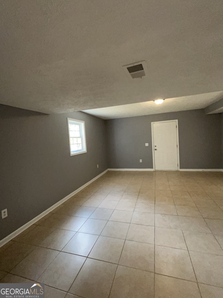 1682 Charmeth Road Lithonia, GA 30058 - Photo 41 of 52 a view of an empty room with a window