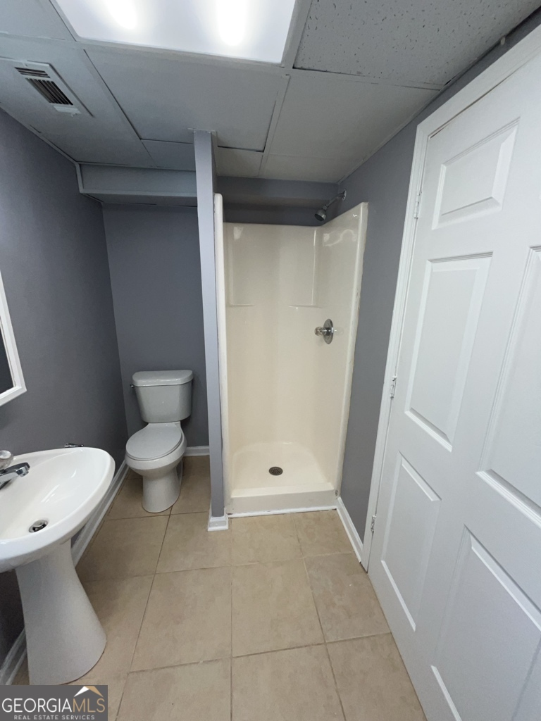 1682 Charmeth Road Lithonia, GA 30058 - Photo 44 of 52 a bathroom with a toilet and a shower