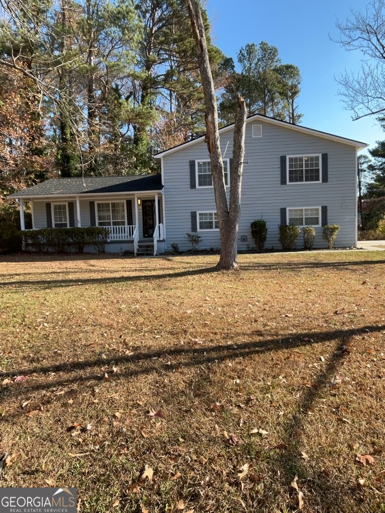 1682 Charmeth Road Lithonia, GA 30058 - Photo 52 of 52 front view of house with yard and trees