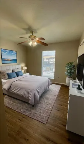 a bedroom with a large bed chandelier and a window