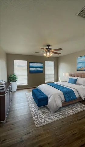 a bedroom with a large bed and a chandelier