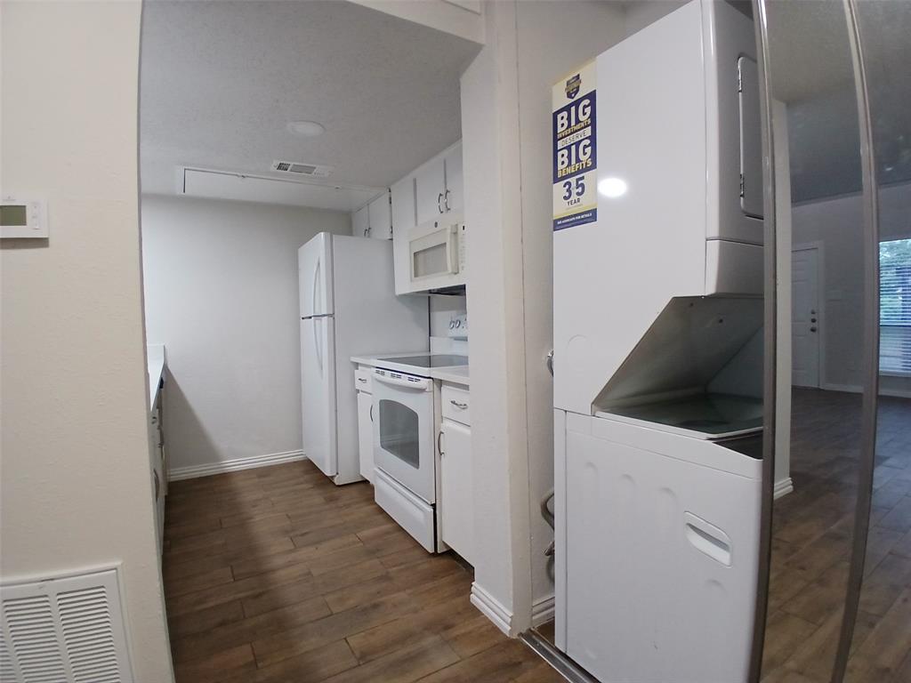 4640 Country Creek Drive, Unit 1257 Dallas, TX 75236 - Photo 5 of 11 a kitchen with white cabinets and white appliances