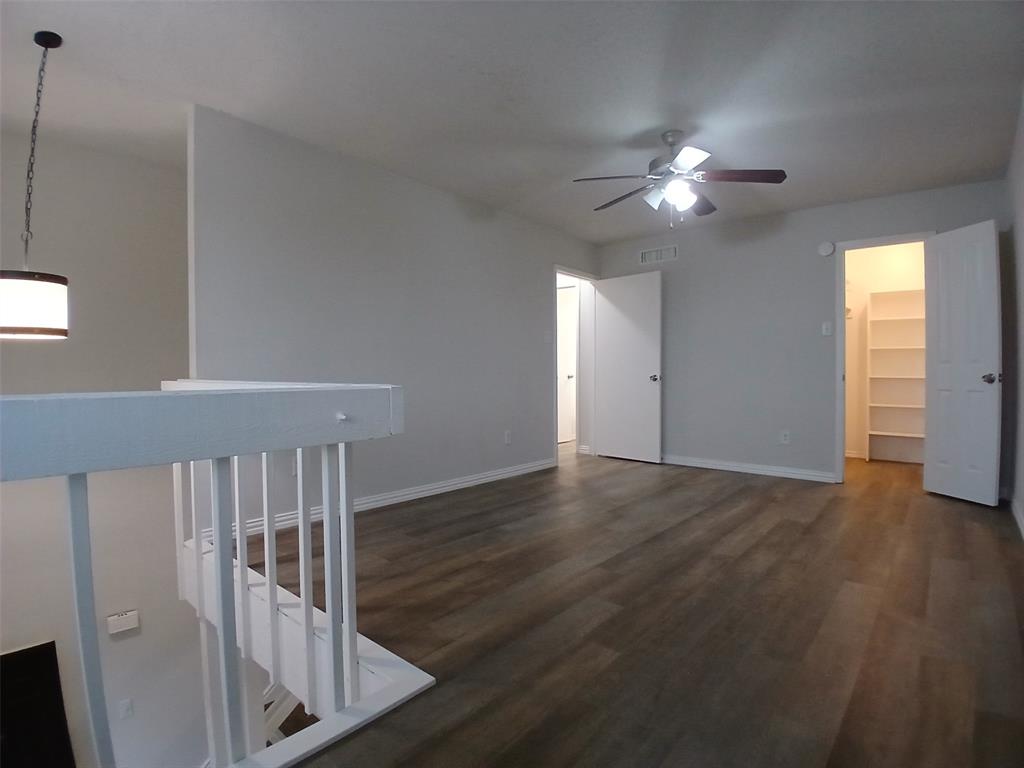 4640 Country Creek Drive, Unit 1257 Dallas, TX 75236 - Photo 6 of 11 a view of an empty room with wooden floor and fan