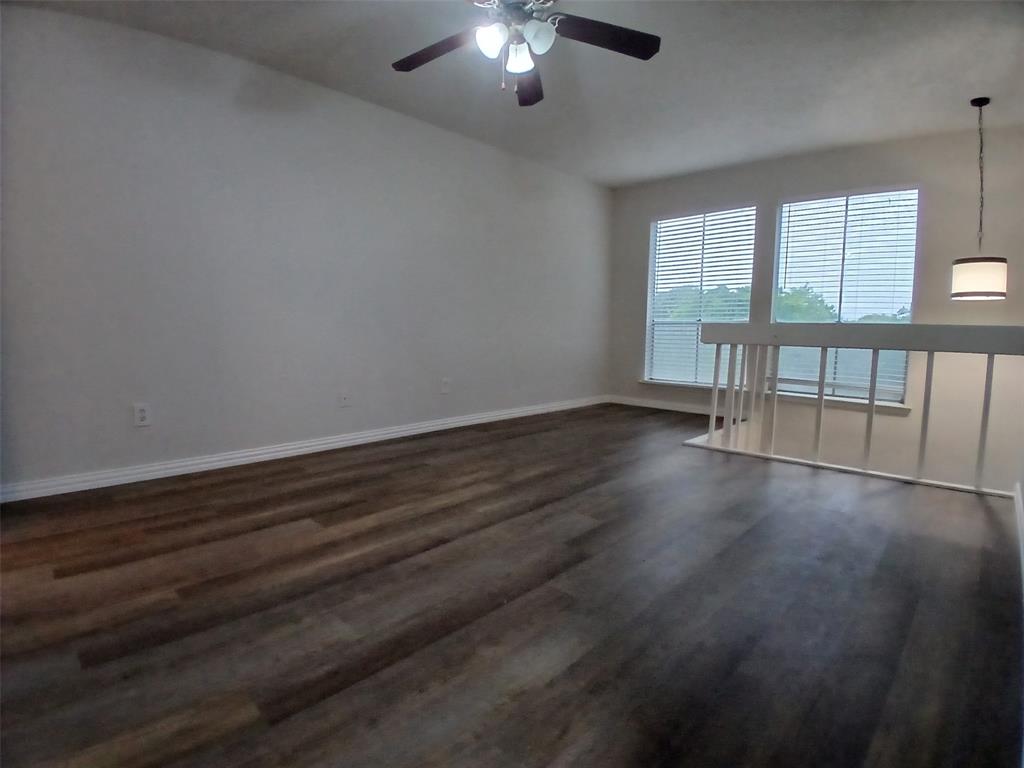 4640 Country Creek Drive, Unit 1257 Dallas, TX 75236 - Photo 7 of 11 a view of an empty room with wooden floor and a window