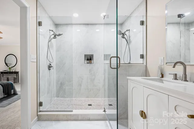 a bathroom with a shower sink and mirror