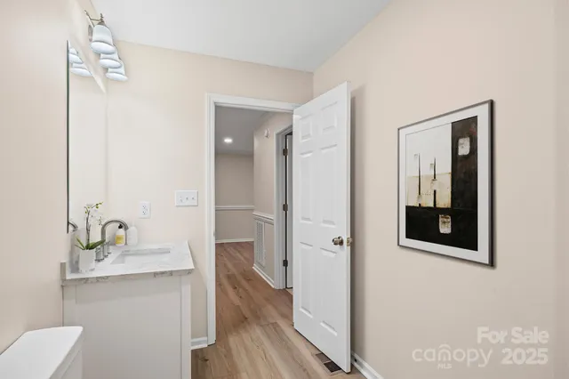 a view of a hallway with wooden floor and entryway