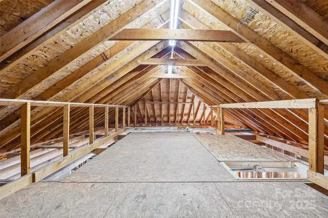an aerial view of a house with swimming pool and large trees
