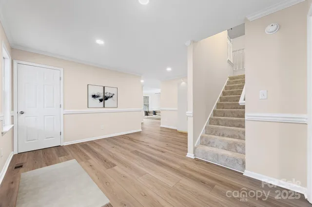 a view of a room with wooden floor and stairs