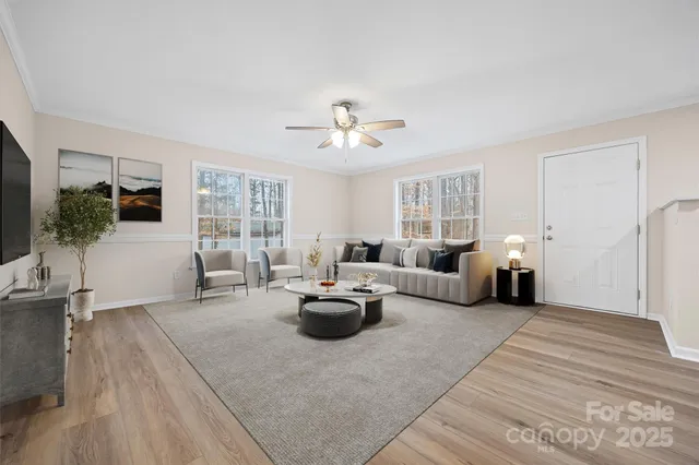 a living room with furniture and view of kitchen
