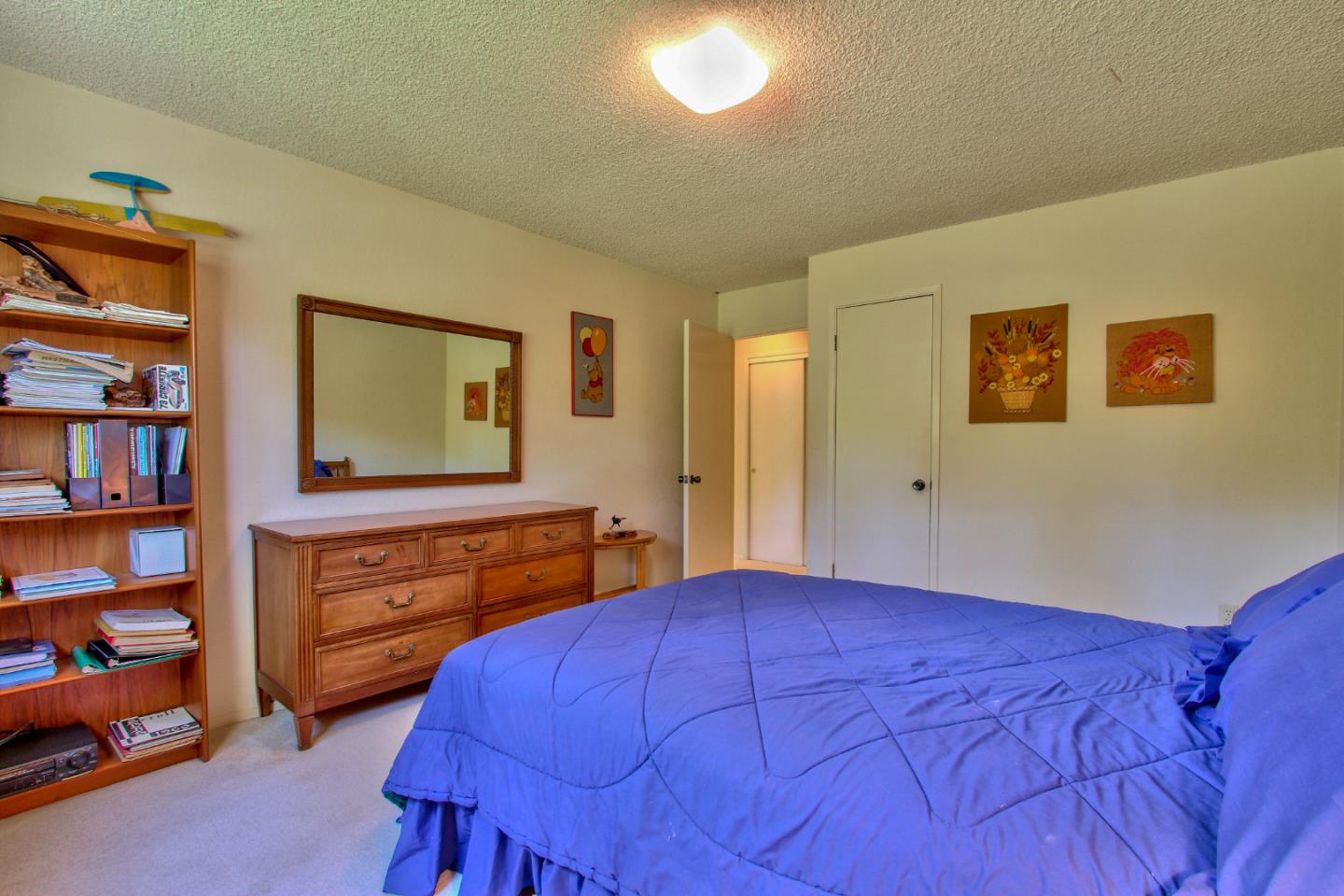 3036 Sloat Road Pebble Beach, CA 93953 - Photo 14 of 22 a bedroom with a bed and a dresser