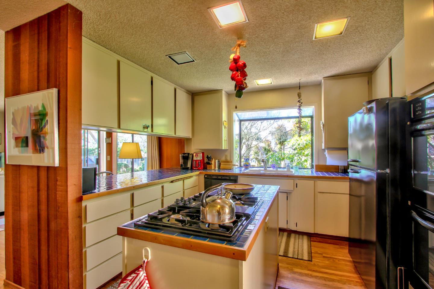 3036 Sloat Road Pebble Beach, CA 93953 - Photo 6 of 22 a kitchen with stainless steel appliances kitchen island granite countertop a refrigerator and a stove top oven