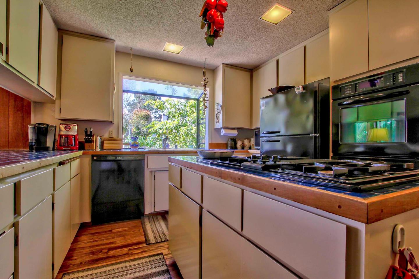 3036 Sloat Road Pebble Beach, CA 93953 - Photo 7 of 22 a kitchen with stainless steel appliances a stove sink and microwave