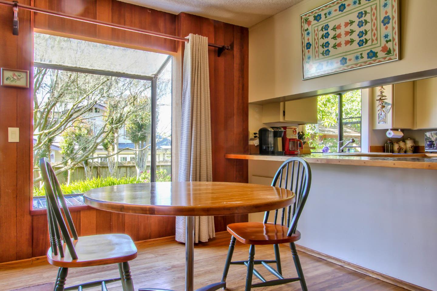 3036 Sloat Road Pebble Beach, CA 93953 - Photo 9 of 22 a view of a dining room with furniture a chandelier and wooden floor