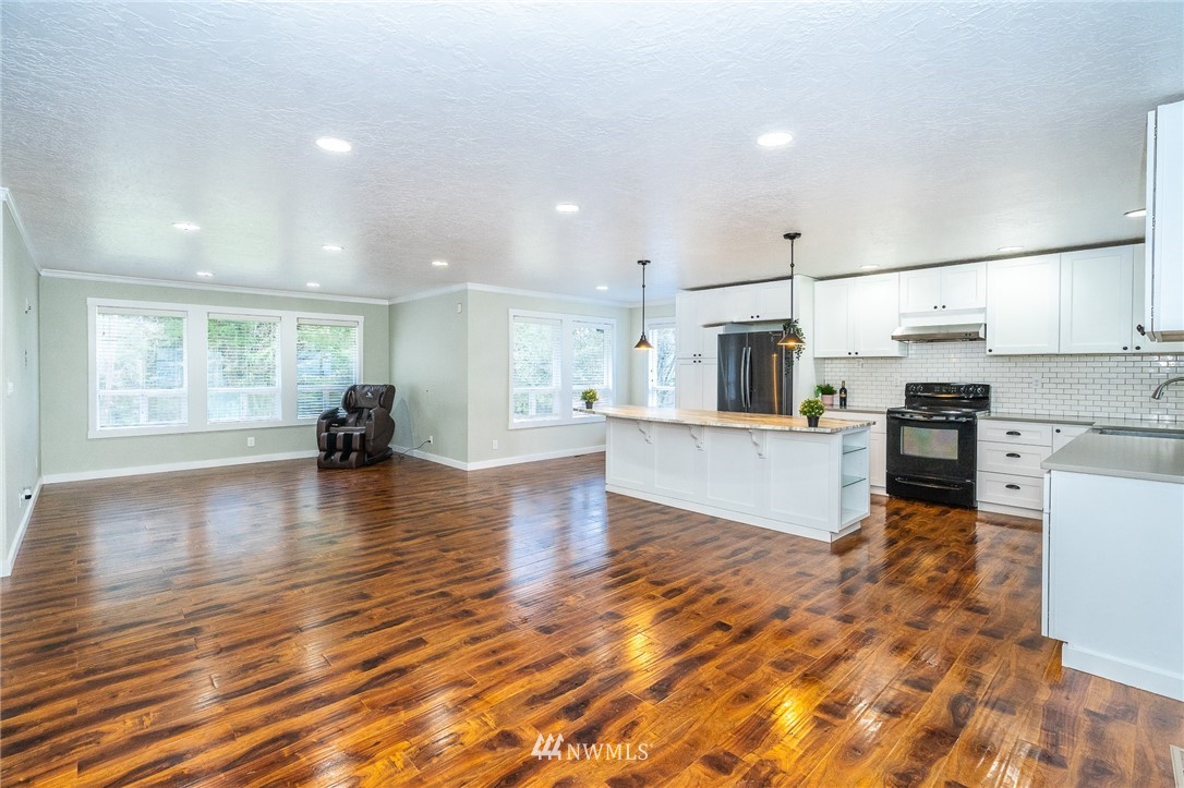 221 Berry Road Chehalis, WA 98532 - Photo 8 of 40 a open kitchen with white cabinets and stainless steel appliances