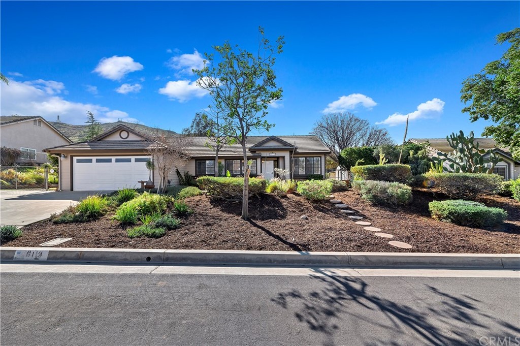 8113 Stone Mist Circle Riverside, CA 92509 - Photo 1 of 1 a front view of a house with a yard and potted plants