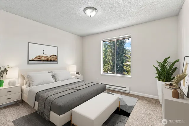 a bedroom with a large bed and a potted plant