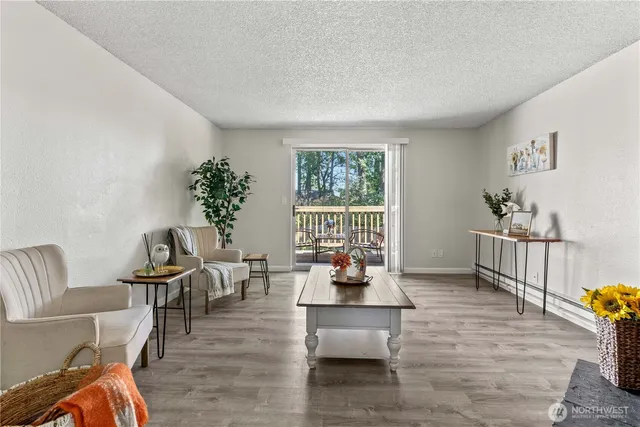 a living room with furniture and wooden floor
