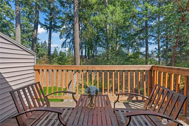 a view of balcony with wooden floor and outdoor seating