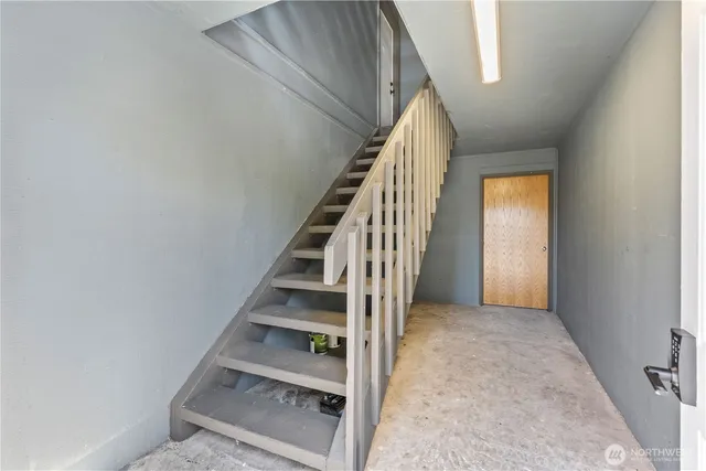 a view of entryway and hall with wooden floor
