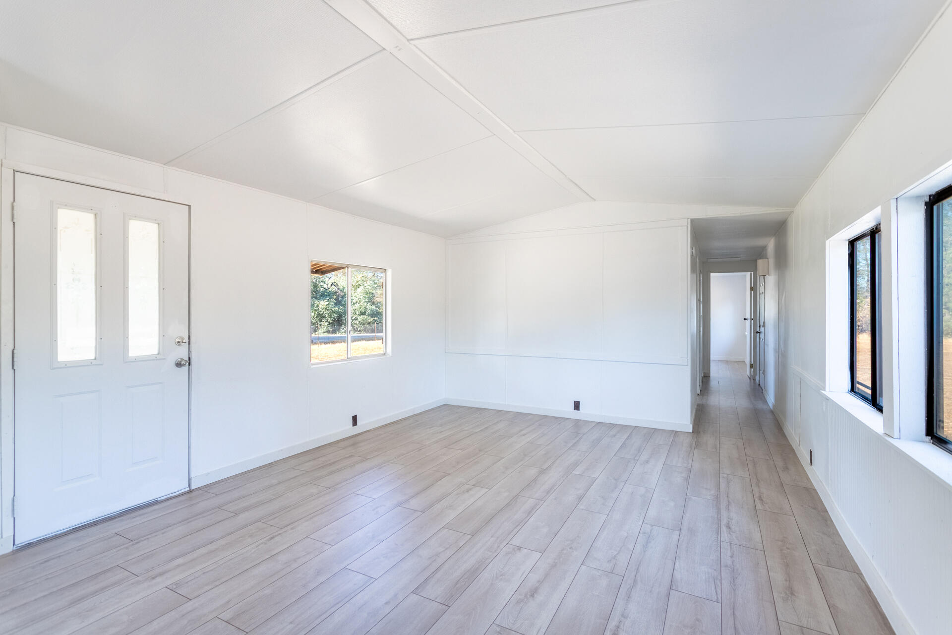 17594 Oly Way Anderson, CA 96007 - Photo 17 of 29 an empty room with wooden floor and windows