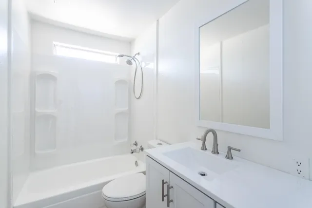 a bathroom with a sink toilet tub and shower